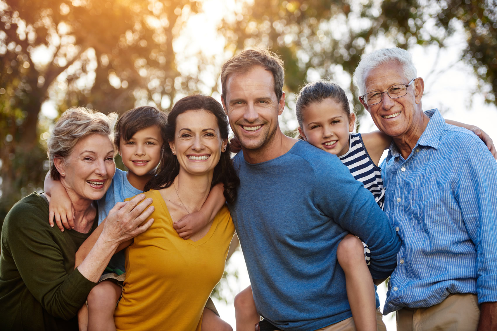 Portrait of a family with two young children posing together outside