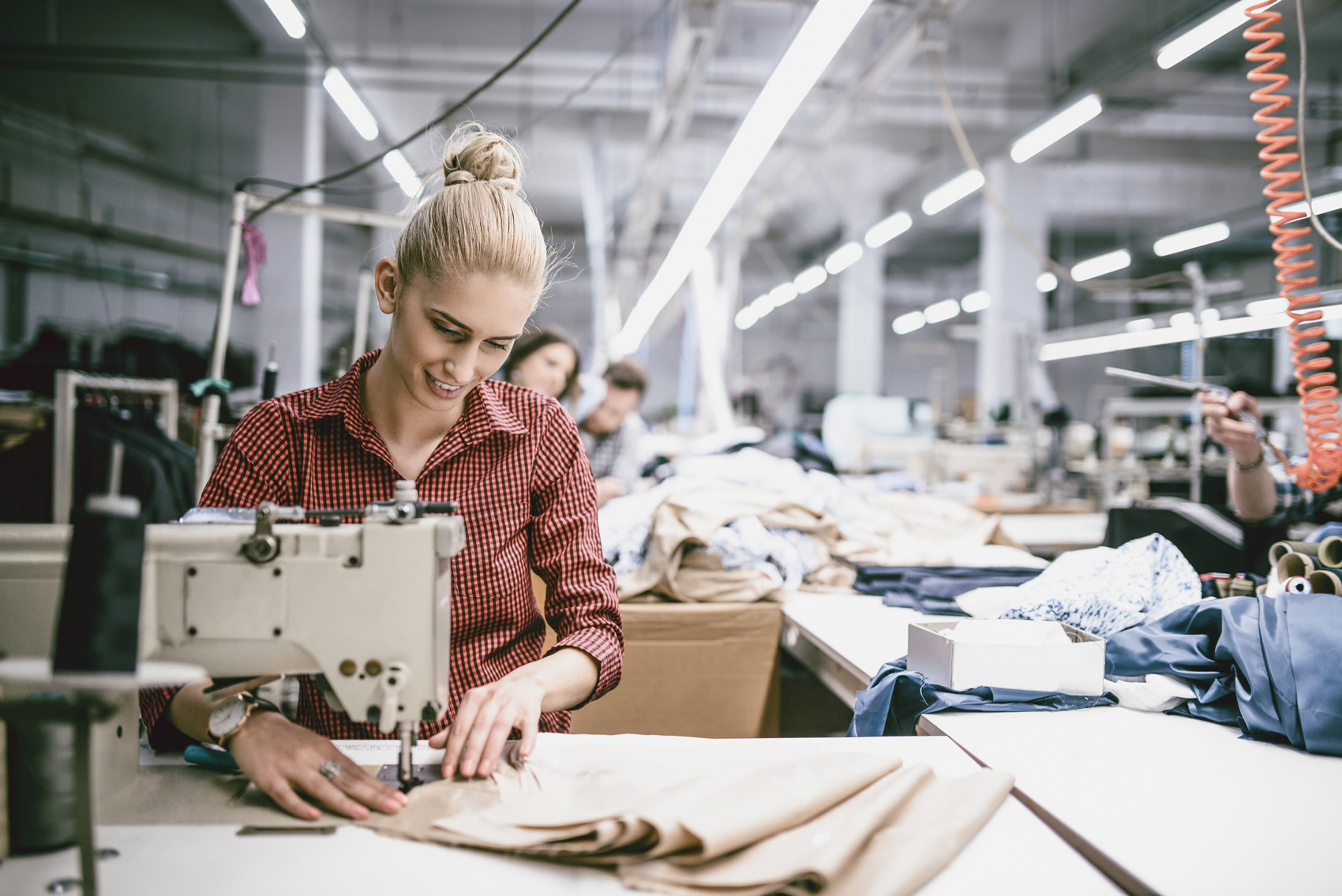 iStock-973535086 Textile Industry Workers Working On Products With New Design